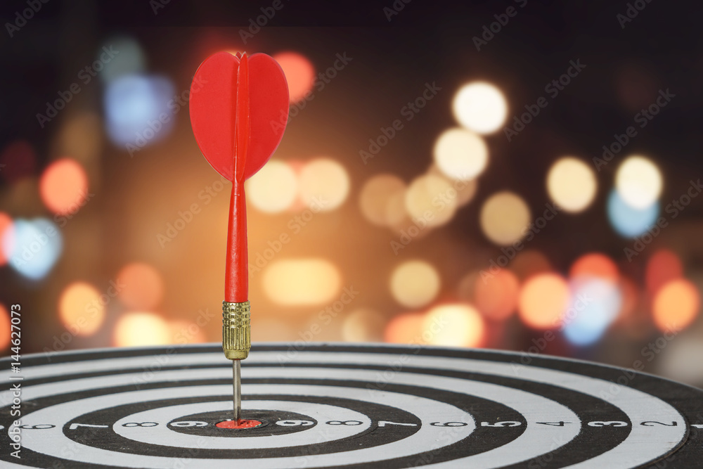 Fototapeta premium target dart with arrow over blurred bokeh background ,metaphor to target marketing or target arrow concept.