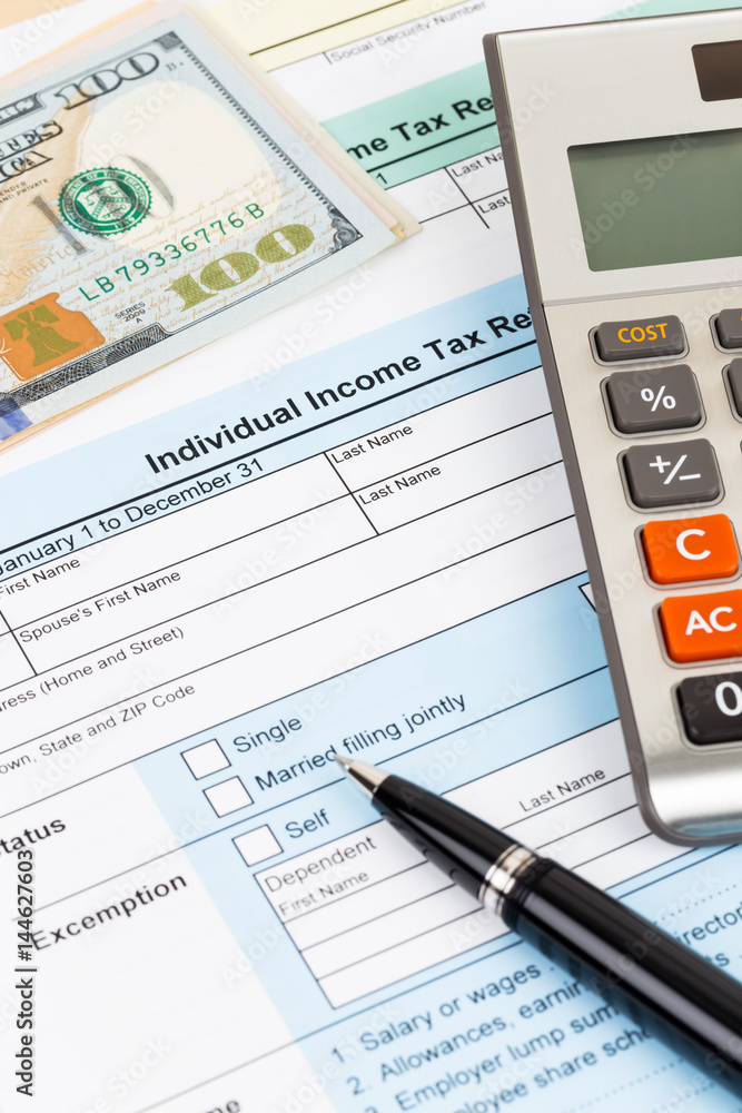 Tax form with calculator, pen, and dollar banknote; document are mock-up Tax form with calculator, pen, and dollar banknote; document are mock-up