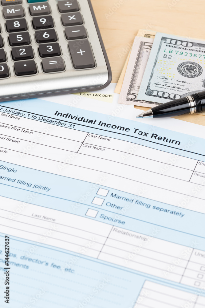 Tax form with calculator, pen, and dollar banknote; document are mock-up Tax form with calculator, pen, and dollar banknote; document are mock-up