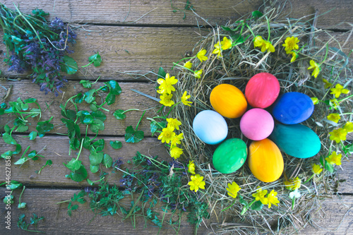 Multicolored easter eggs on a wooden. photo