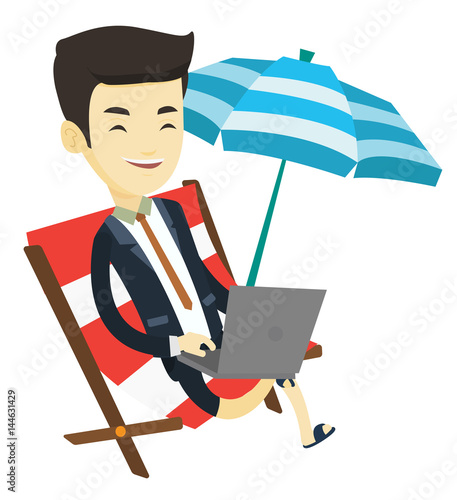 Business man working on laptop at the beach.