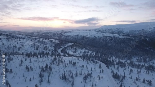 Slow flight in northern mountains in winter photo