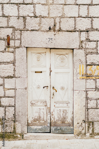 Old white doors. Wood texture. Old shabby, irradiated paint