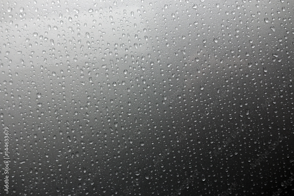 The background of a drop of rain drips down the glass The background of a drop of rain drips down the glass