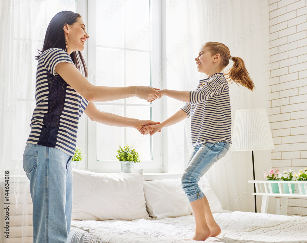 Fototapeta premium Mom and her daughter are playing