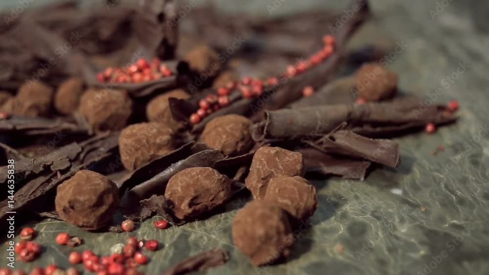 close up rotation shot of Composition with truffles in cocoa dust with red pepper and chocolate chips. close up rotation shot of Composition with truffles in cocoa dust with red pepper and chocolate chips.