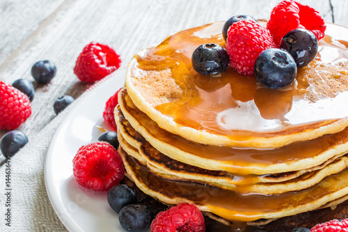 homemade pancakes with fresh berries and caramel sauce