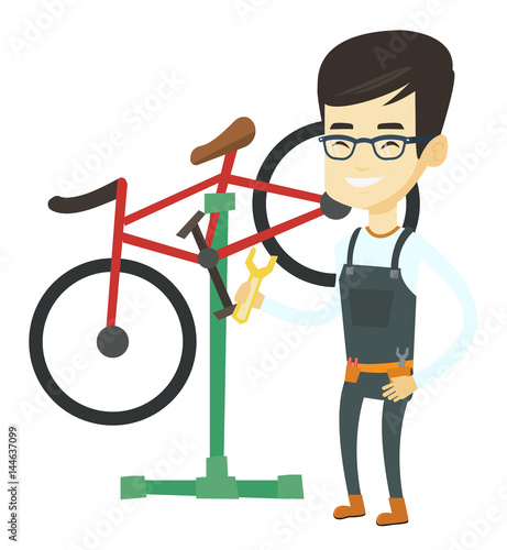 Asian bicycle mechanic working in repair shop.