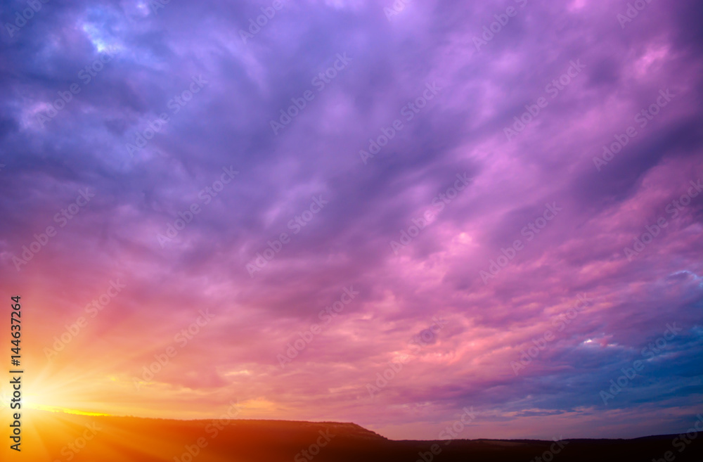 Photo of a violet sunset with clouds and sun Photo of a violet sunset with clouds and sun