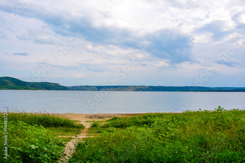 Photo of a beautiful beach near blue bay at summer