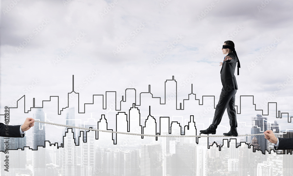 Business concept of risk support and assistance with man balancing on rope Business concept of risk support and assistance with man balancing on rope