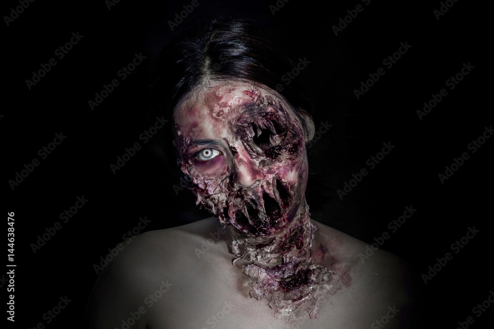  horrible scary zombie girl on black background with copyspace