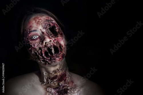  horrible scary zombie girl on black background with copyspace