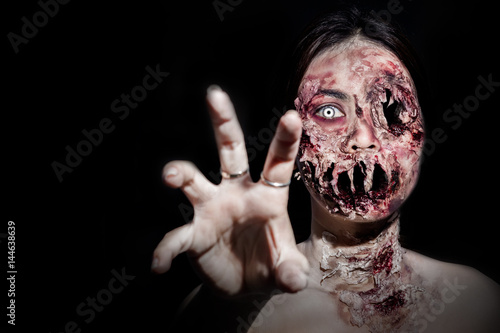  horrible scary zombie girl on black background with copyspace