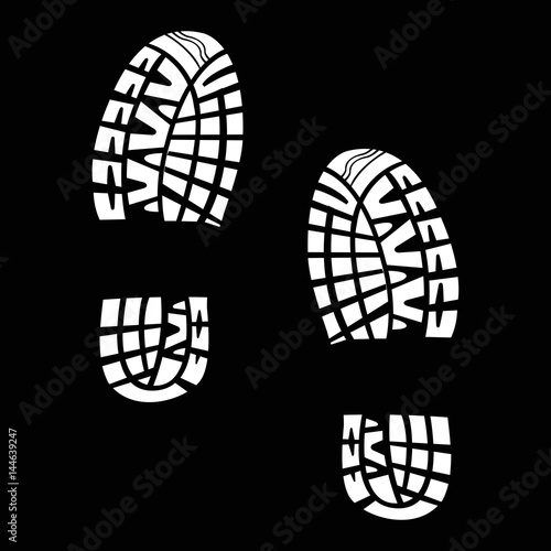 White tracks from shoes on a black background
