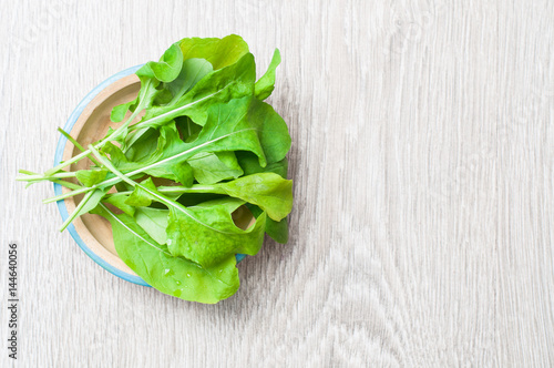 Salad  arugula on a wooden background  top view