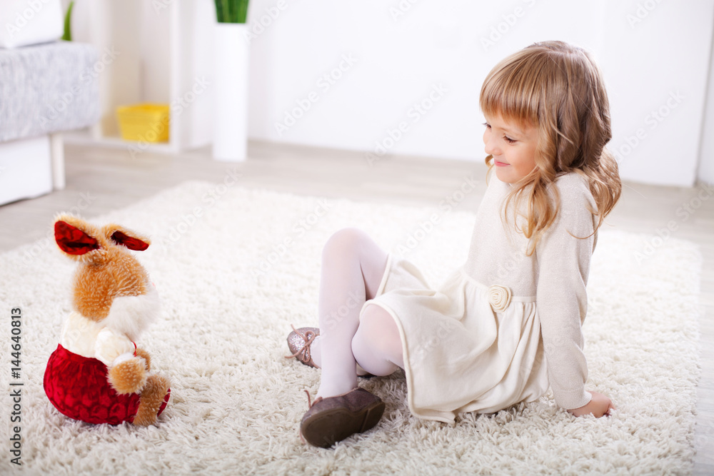 Little girl playing with a toy. Stock Photo | Adobe Stock