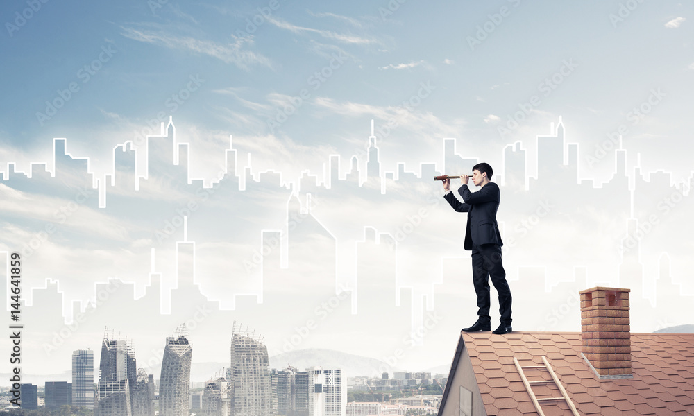 Engineer man standing on roof and looking in spyglass. Mixed med Engineer man standing on roof and looking in spyglass. Mixed med