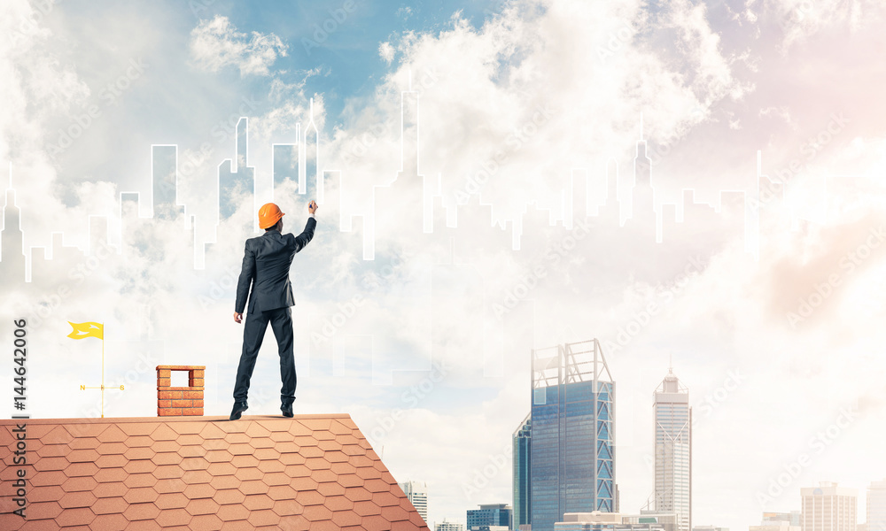 Man architect draw silhouette of modern city on blue sky. Mixed Man architect draw silhouette of modern city on blue sky. Mixed