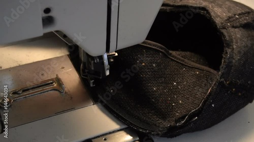 Dressmaker sewing cap on the sewing machine