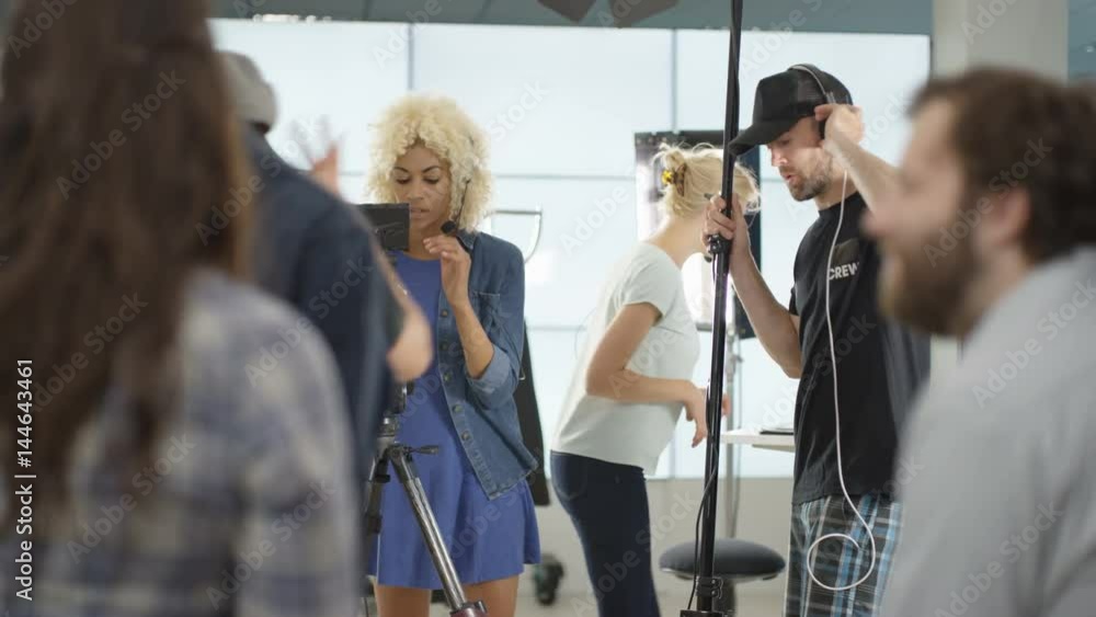 Behind the scenes with TV or film production crew working together on set Behind the scenes with TV or film production crew working together on set