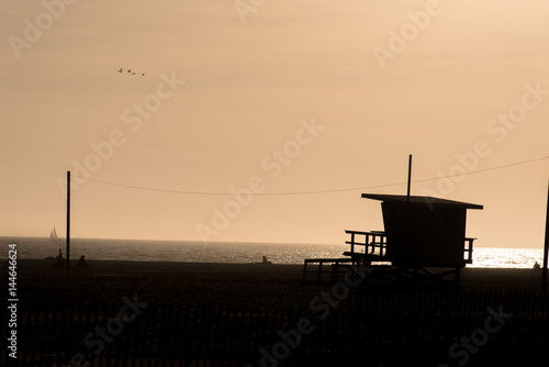 Silhouette of Santa Monica Pier sunset orange sky without cloud, Los Angeles, USA.