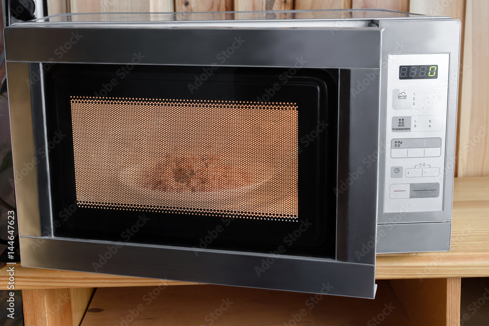 Microwave oven on a wooden background Microwave oven on a wooden background