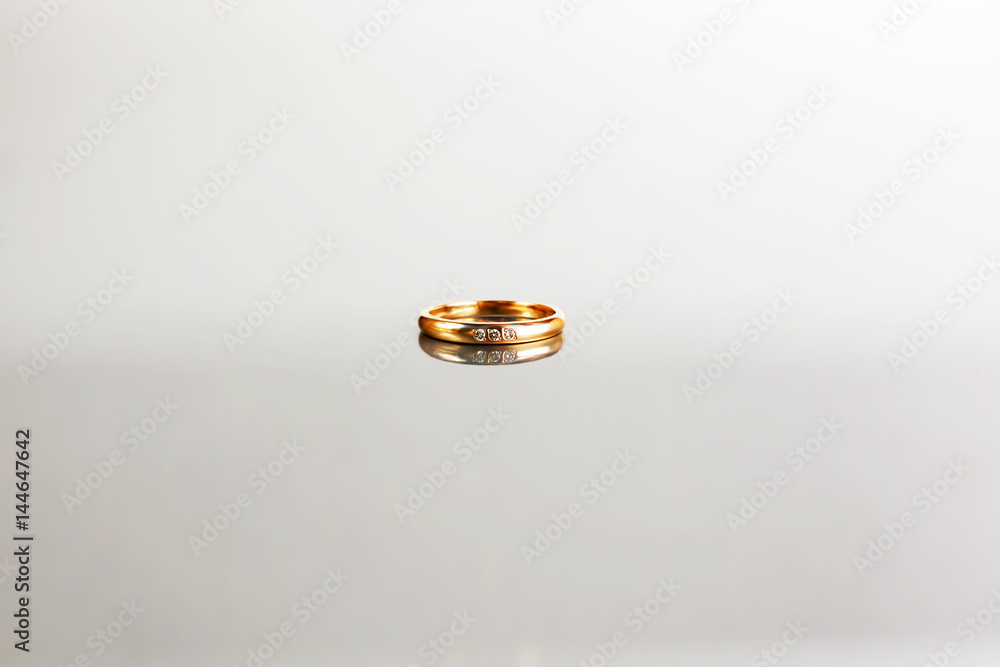 Golden ring on white background with reflection Golden ring on white background with reflection