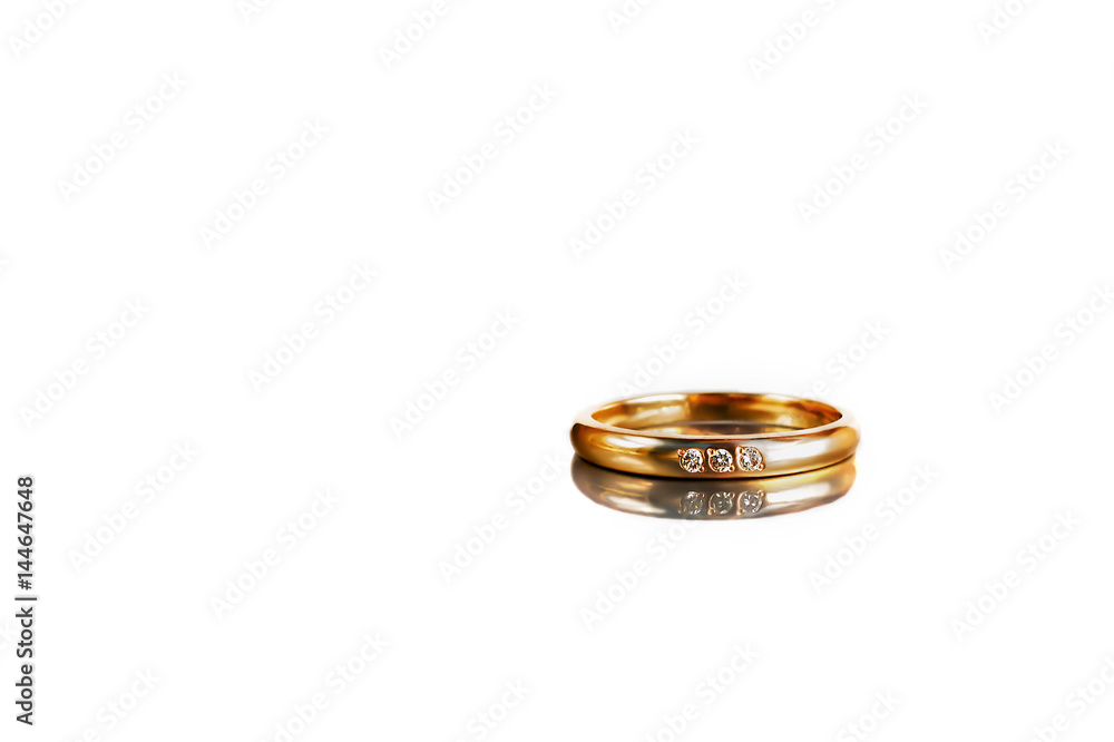 Golden ring on white background with reflection Golden ring on white background with reflection