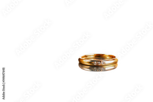 Golden ring on white background with reflection