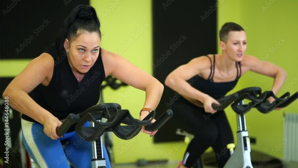 Women are actively engaged in group bike training to maintain physical fitness. Cicle training is a good cardio load on the body of athletes before the upcoming physical exercises. Women are actively engaged in group bike training to maintain physical fitness. Cicle training is a good cardio load on the body of athletes before the upcoming physical exercises.