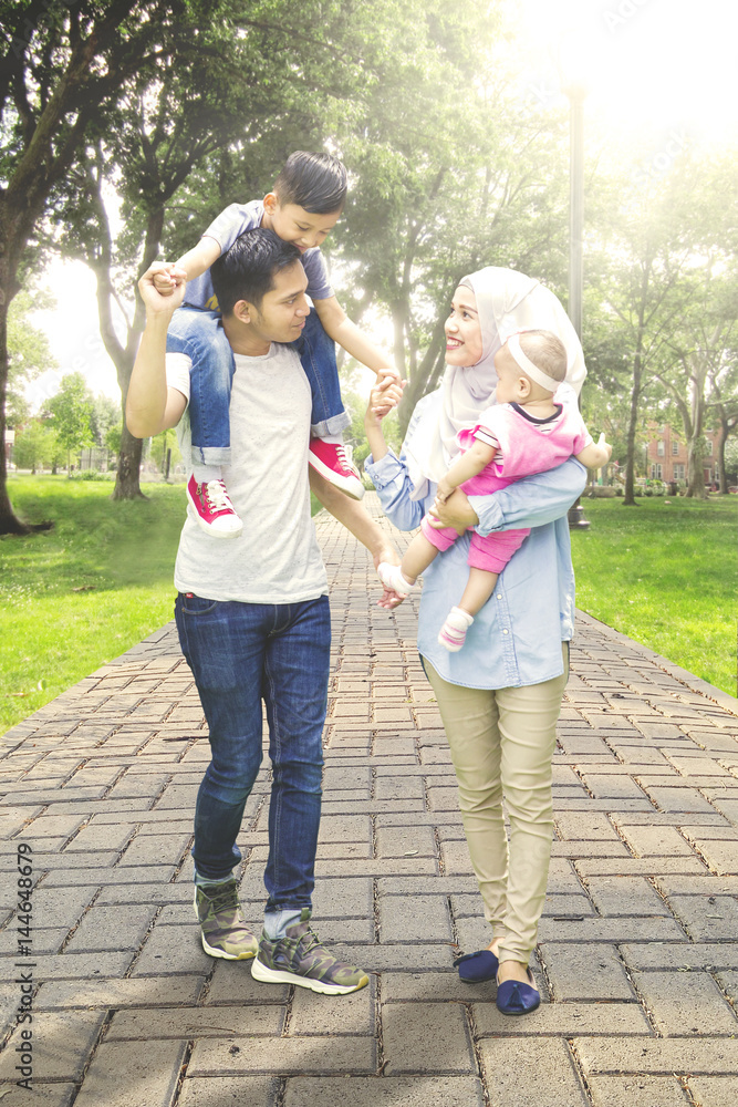 Muslim Asian family walk in the park Muslim Asian family walk in the park