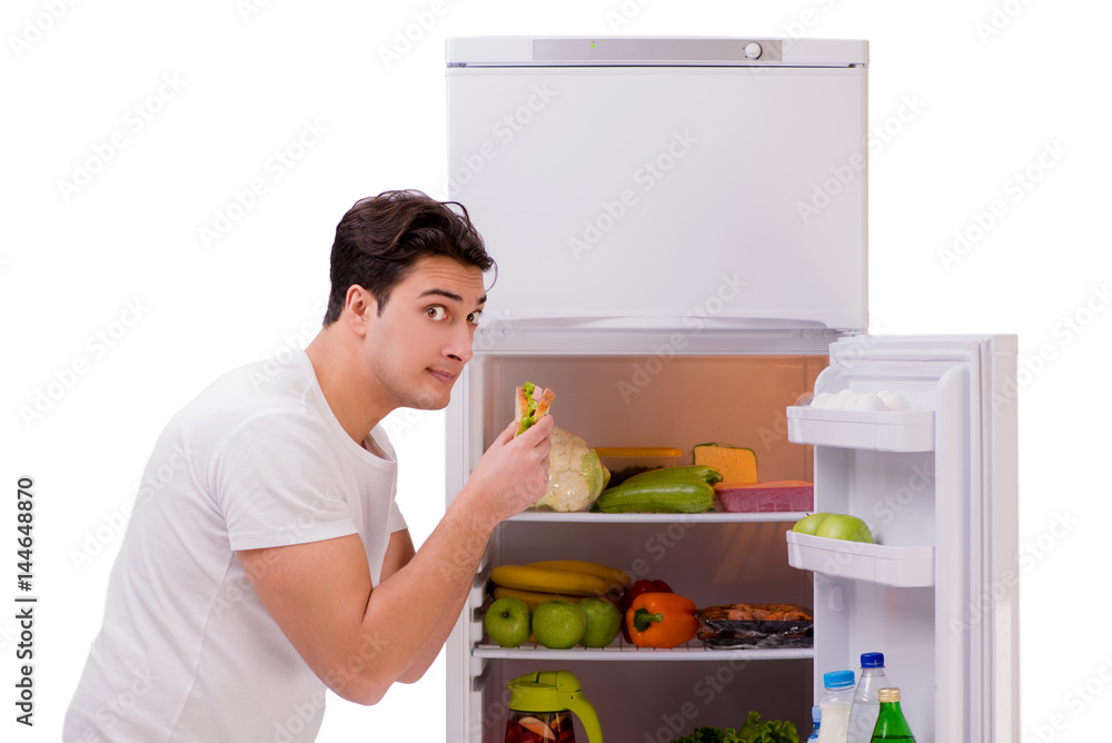 Man next to fridge full of food Man next to fridge full of food