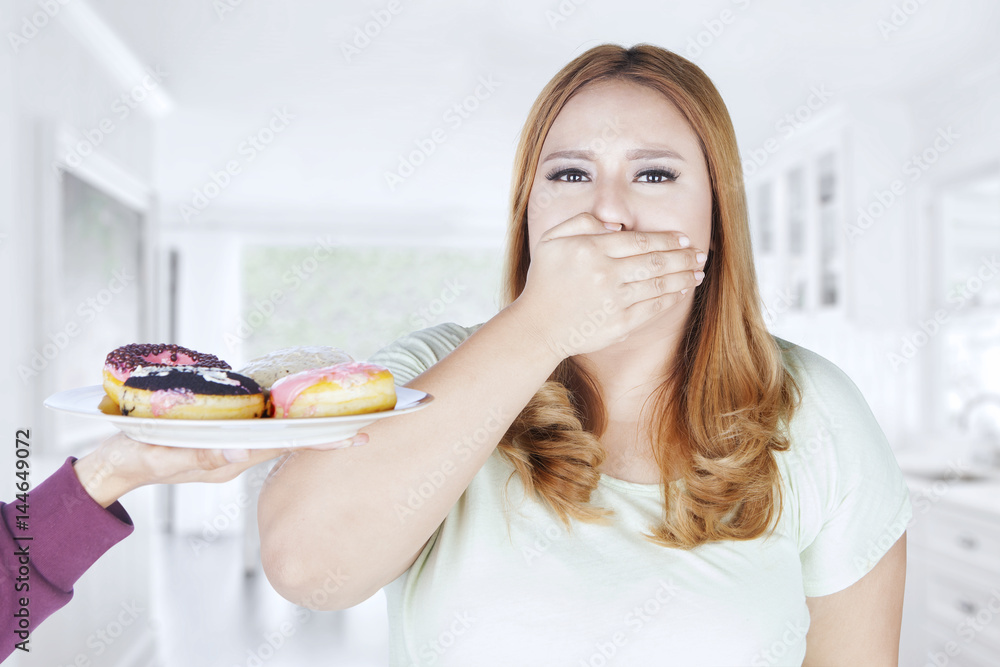 Obese woman closed mouth for donuts Obese woman closed mouth for donuts