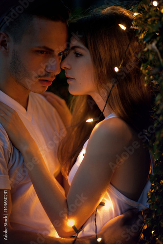 Loving couple in garland lights