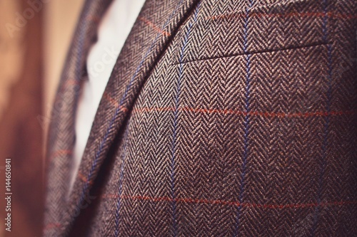 Photos Classic tweed men's jacket with closeup on wool fabric texture