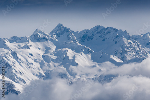 Snow mountains peaks covered by clouds on the sun  © Pavel Burchenko