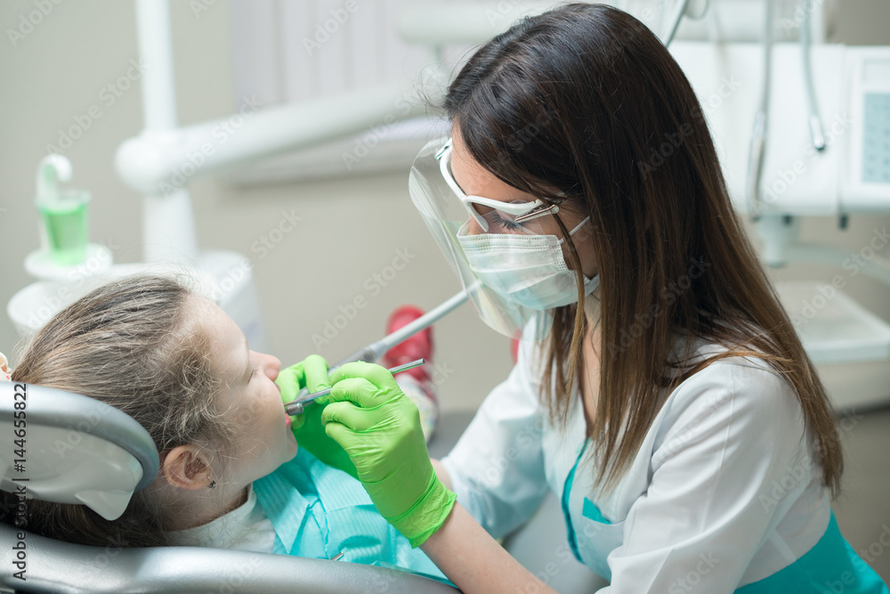 dentist treating child's teeth dentist treating child's teeth