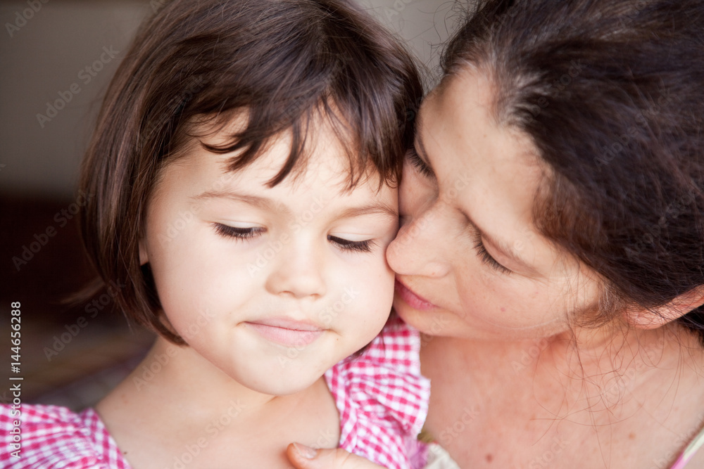 Grandmother kissing granddaughter Grandmother kissing granddaughter