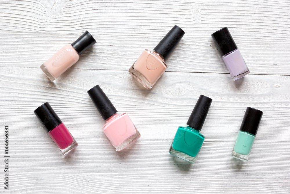 Bottles with nail polish over white background top view Bottles with nail polish over white background top view
