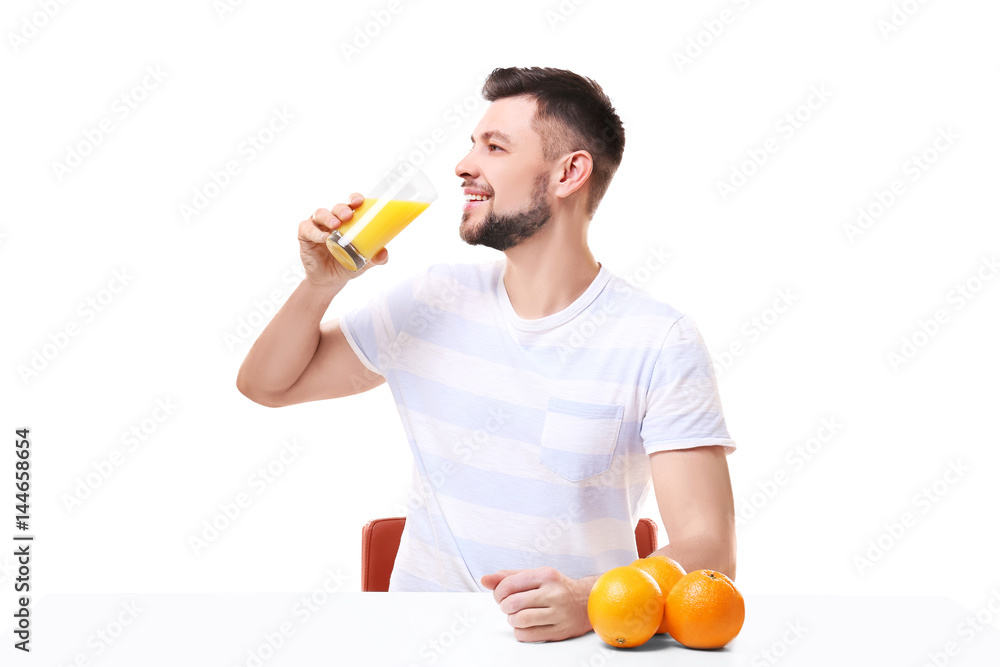 Handsome man posing with juice on white background Handsome man posing with juice on white background