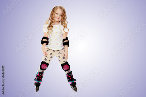 Little girl roller-skates.