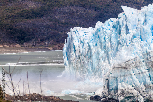Ice falling from Perito Moreno glacier causing a big wave, Argentina