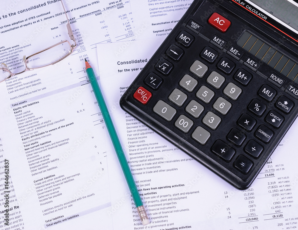 Office Desk with papers lying a calculator and a pencil Office Desk with papers lying a calculator and a pencil