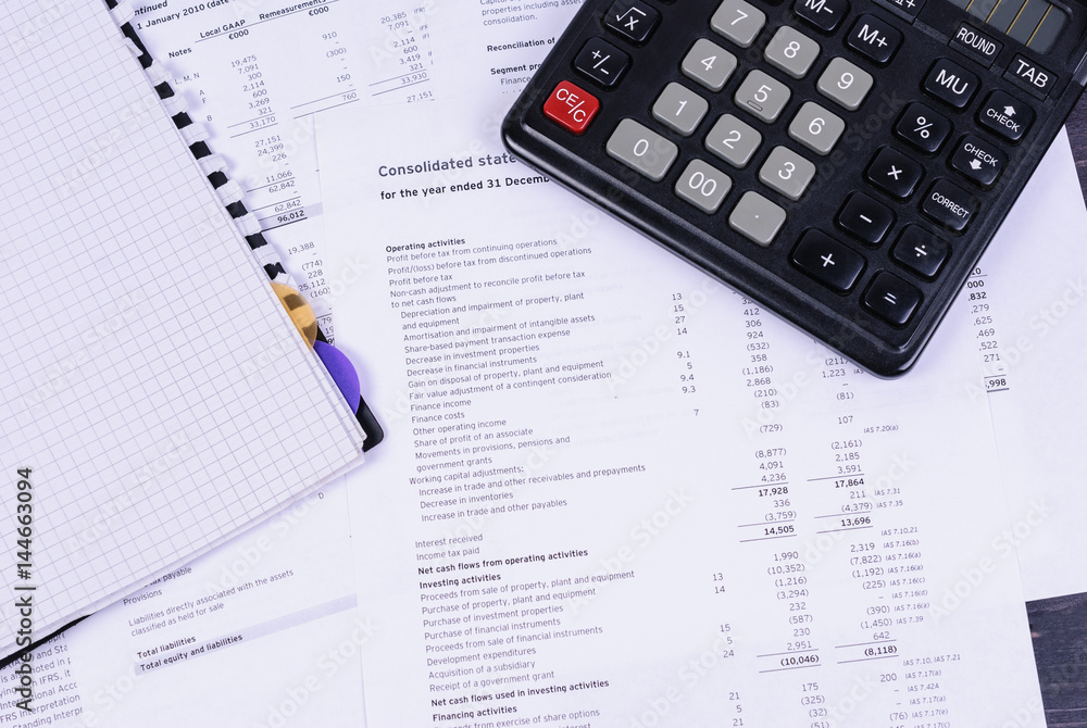 Table with diary, calculator and business documents. Table with diary, calculator and business documents.