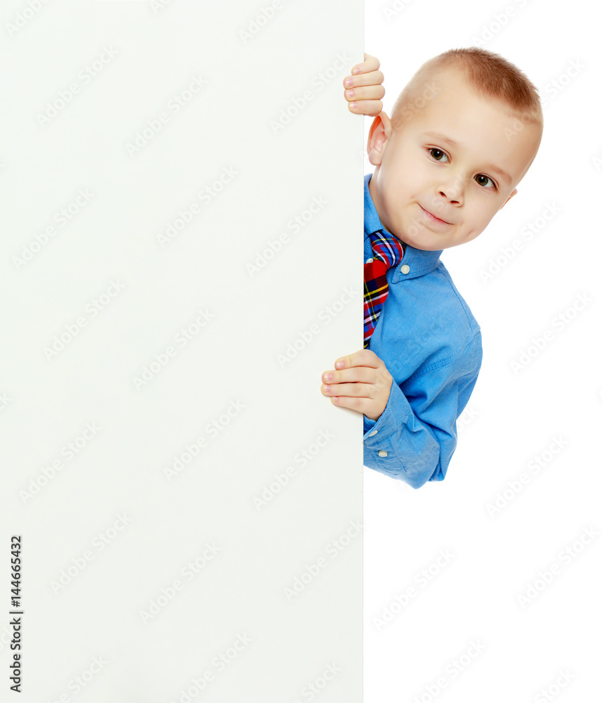 boy peeks out from behind the banner boy peeks out from behind the banner