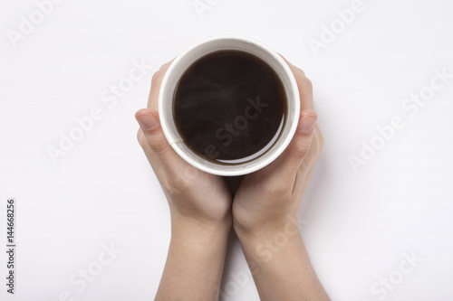 woman hand hold a paper cup with coffee isolated white.