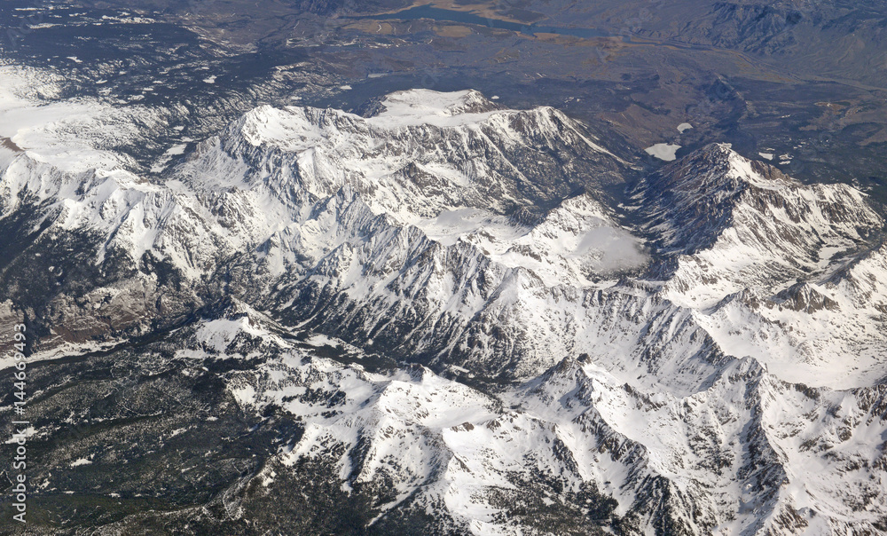 Aerial view of beautiful snow covered mountains, clouds and alpine landscape of the Rocky Mountains, Colorado
