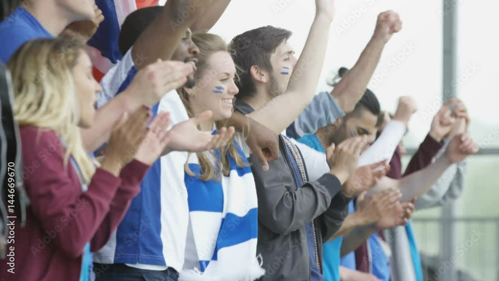Excited sports fans at live event clapping & cheering for their team Excited sports fans at live event clapping & cheering for their team