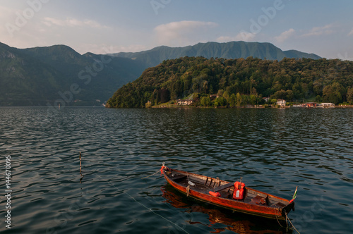 Lake Como and fisherman boat - early morning in summer season. © Wipark